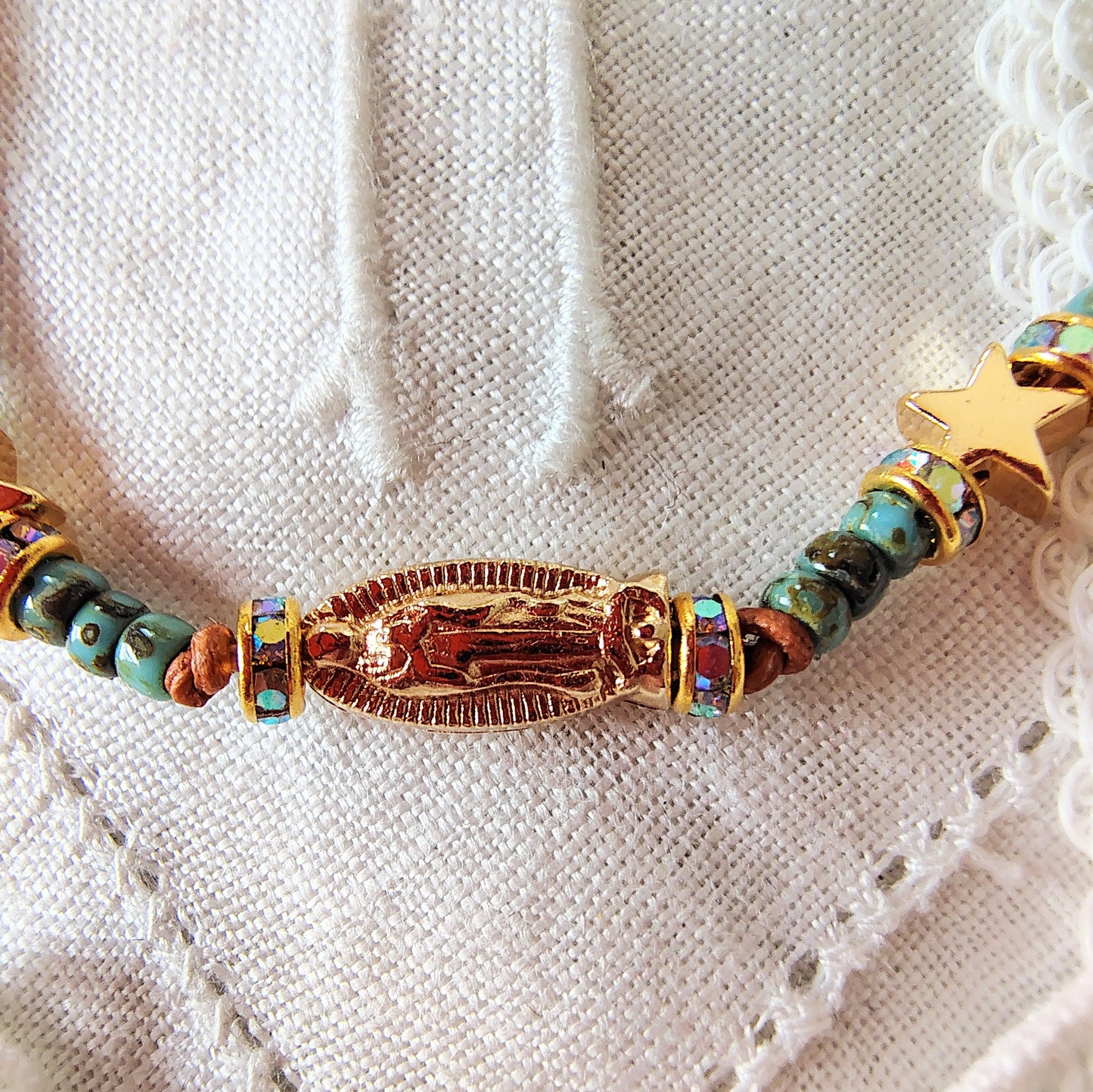 Our Lady of Guadalupe adjustable handmade bracelet with Cobalt blue or teal Miyuki Picasso beads and aaa Crystal rondeles, .5mm leather cord