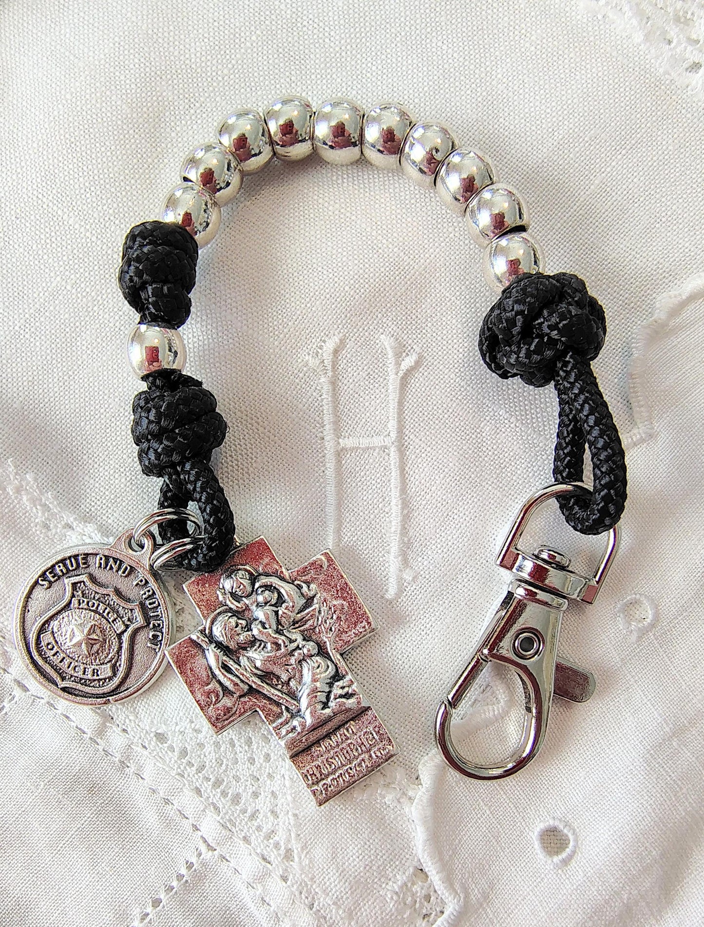 Rosary paracord police protection sheriff tenner prayer beads Saint Michael ice border patrol Saint Benedict crucifix spiritual warfare gift