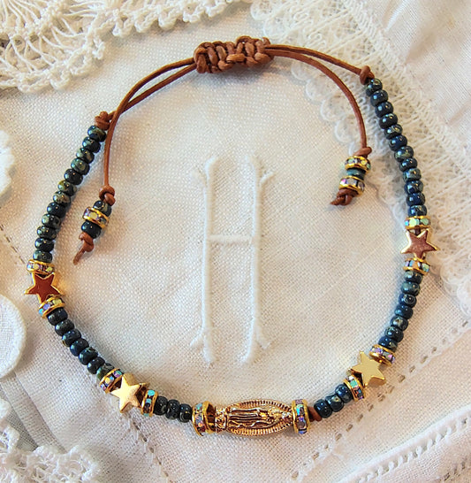 Our Lady of Guadalupe adjustable handmade bracelet with Cobalt blue or teal Miyuki Picasso beads and aaa Crystal rondeles, .5mm leather cord