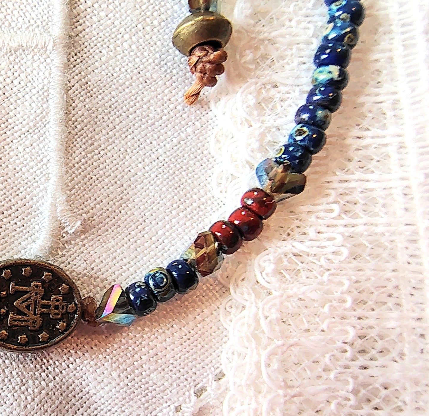 Miraculous Medal adjustable handmade bracelet with Cobalt blue Miyuki beads, red opaque Picasso Beads and Multi-colored pyramid beads